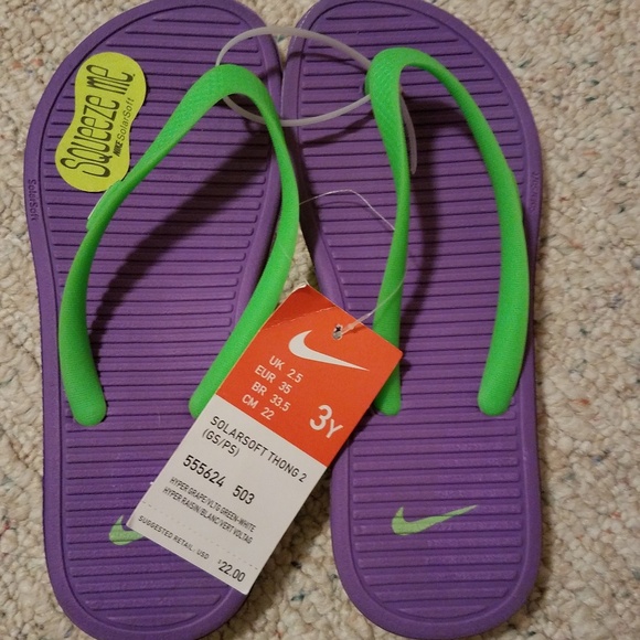 purple nike flip flops
